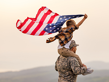 Military,Man,Father,Carrying,Happy,Little,Son,With,American,Flag - Billy The Sunshine Plumber